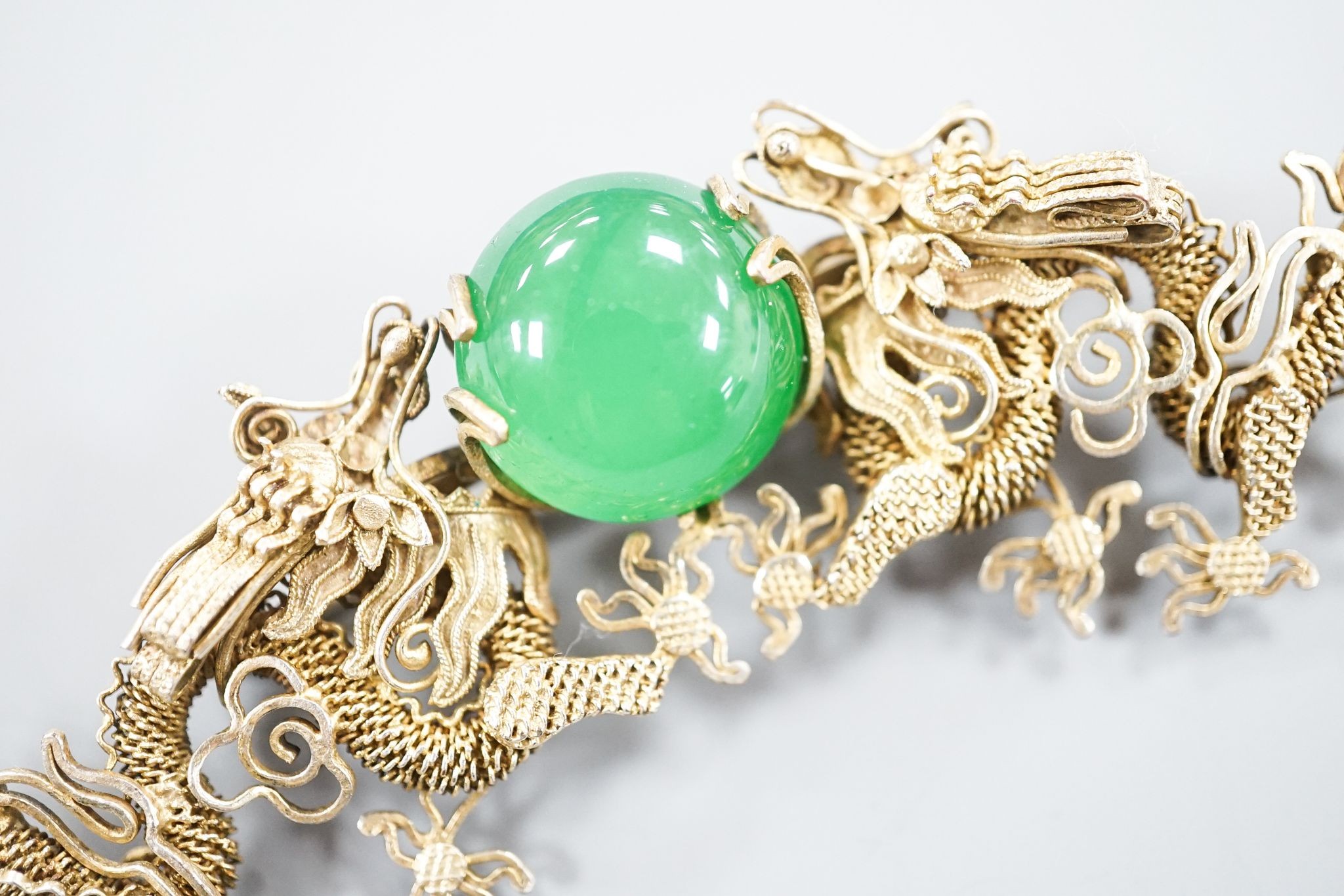 A Chinese gilt white metal and green cabochon set dragon brooch, 89mm.